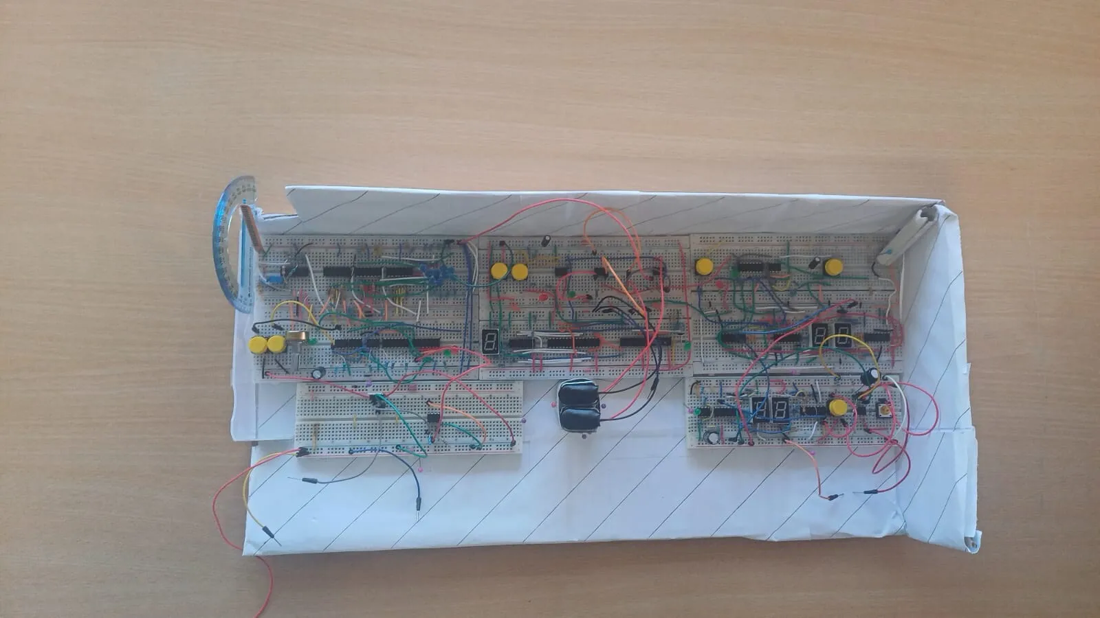 CryptoBox breadboard build - several breadboards of logic chips, LEDs and jumper wires mounted in a white box.